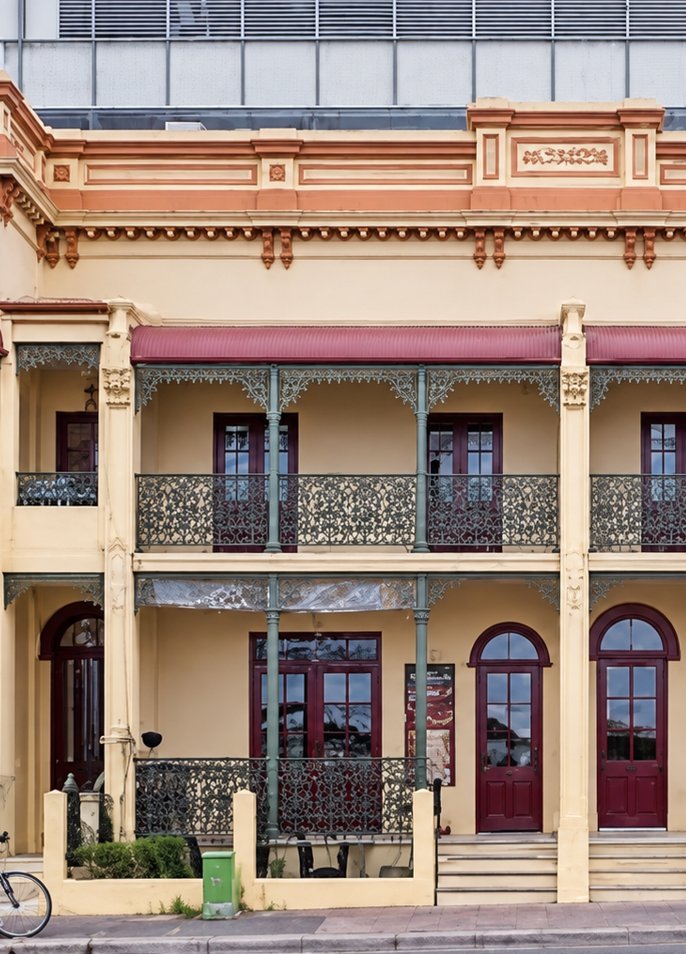 Restored Victorian terrace facade with cast-iron balconies